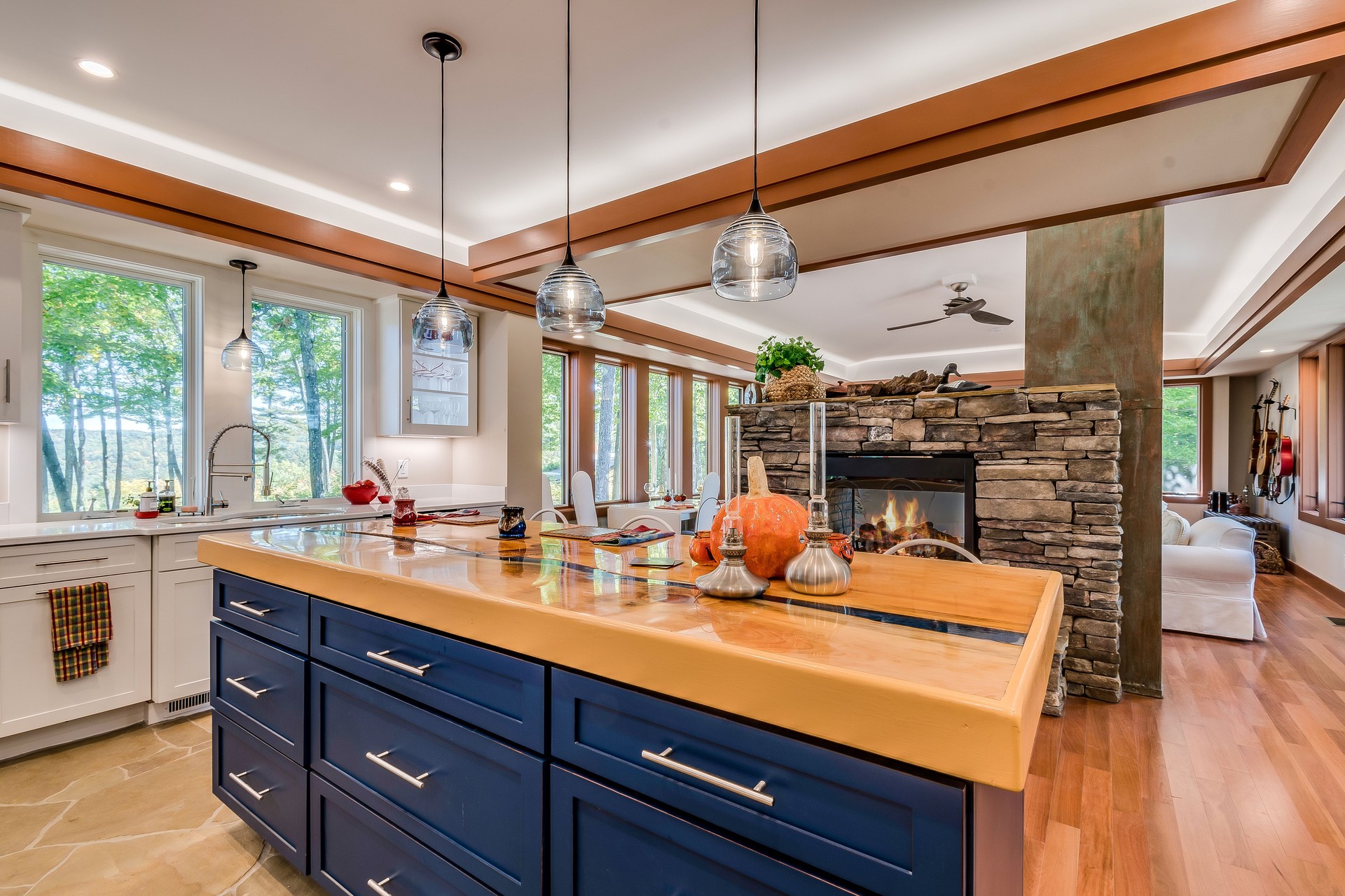 Open kitchen with stand alone fireplace in the middle of the room
